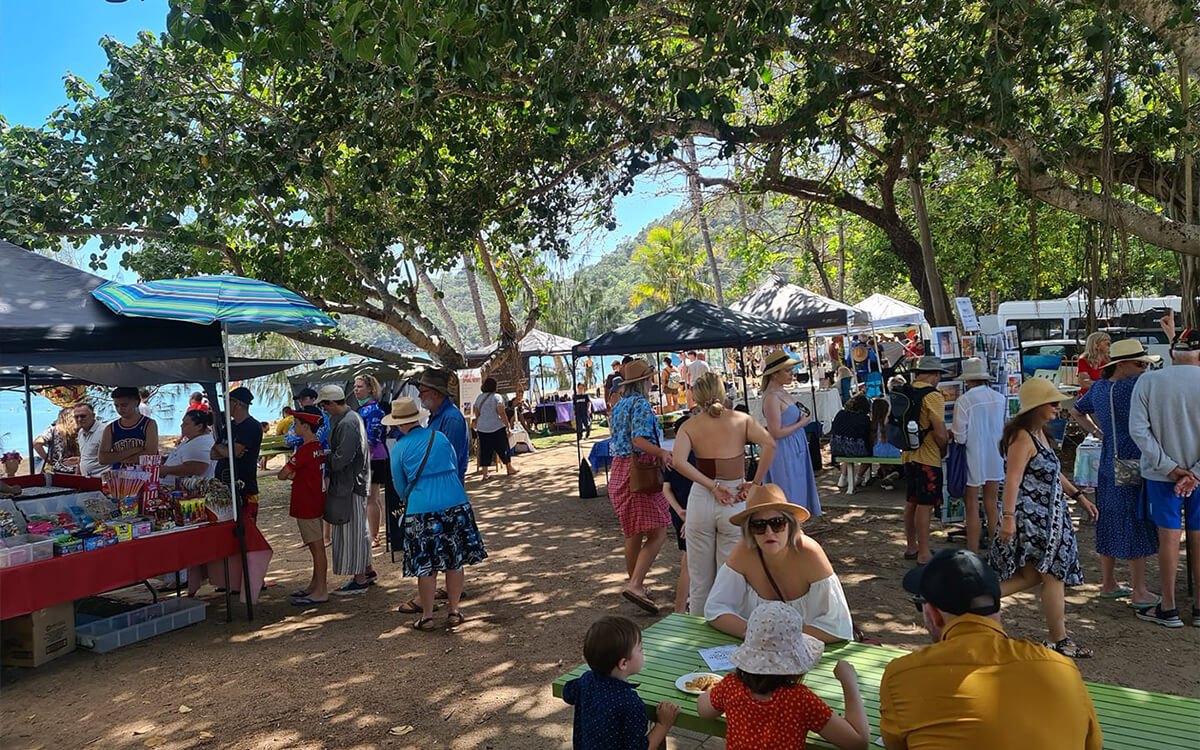 Market stalls under the trees by the beach