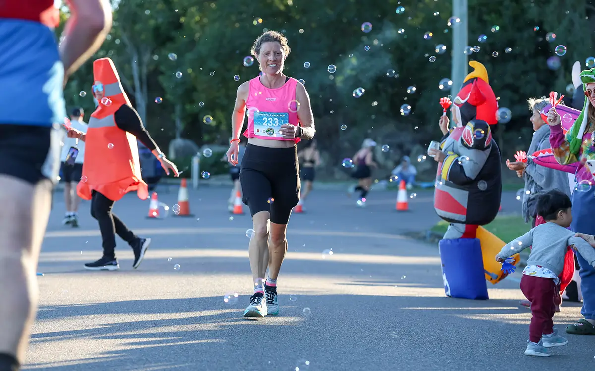 Woman running surrounded with bubbles
