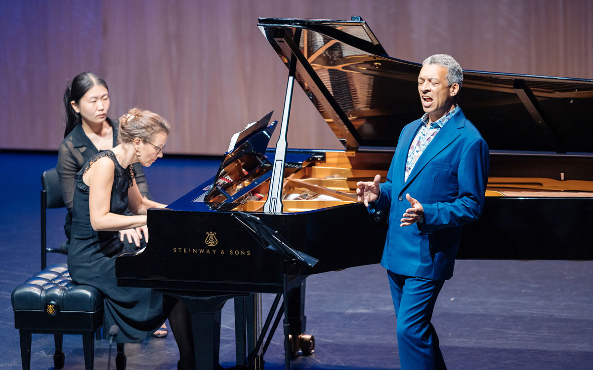 Performers singing and playing the piano