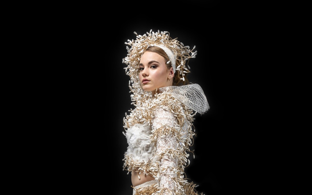 Woman wearing white dress and white headpiece