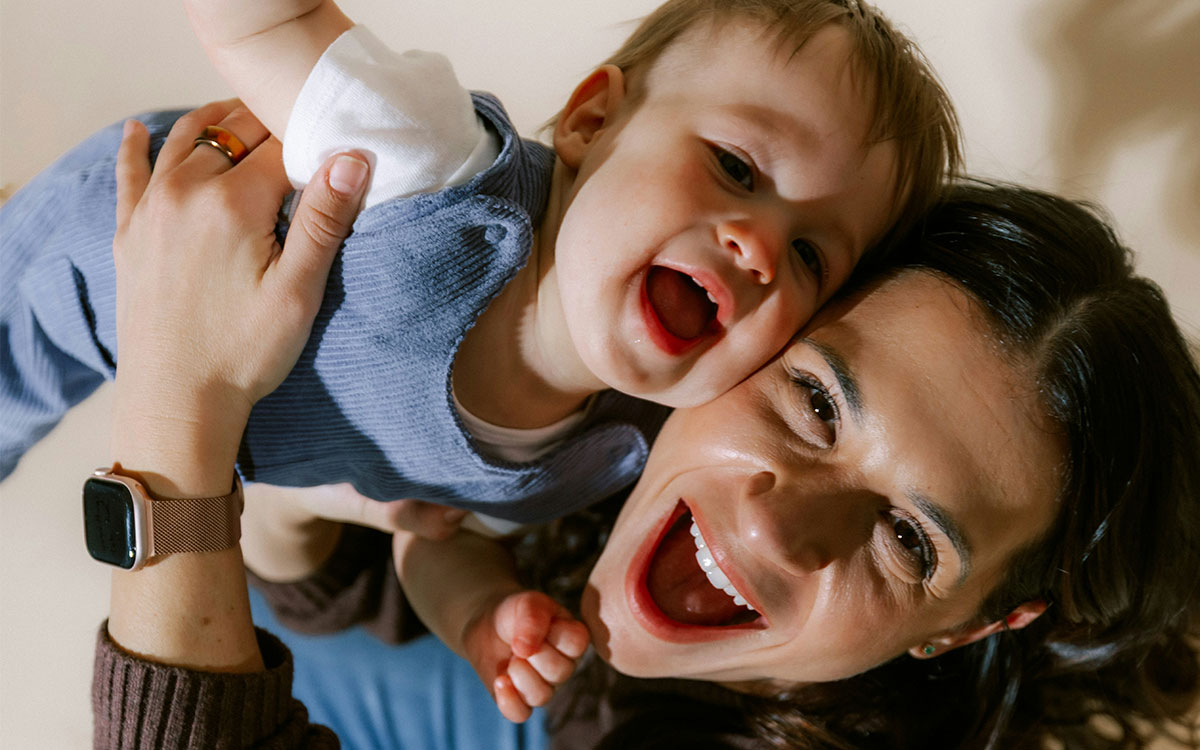 Mother and baby smiling at camera