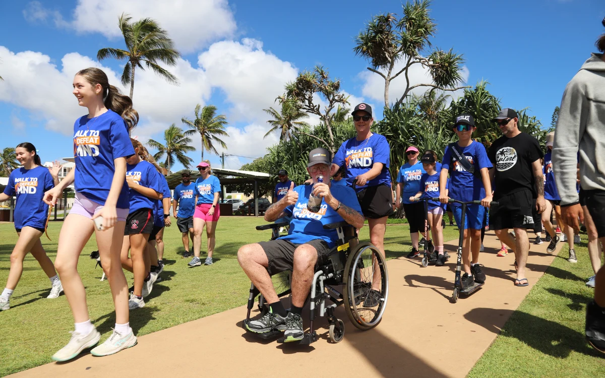 Participants enjoying The Strand including a man in a wheelchair giving a thumbs up.