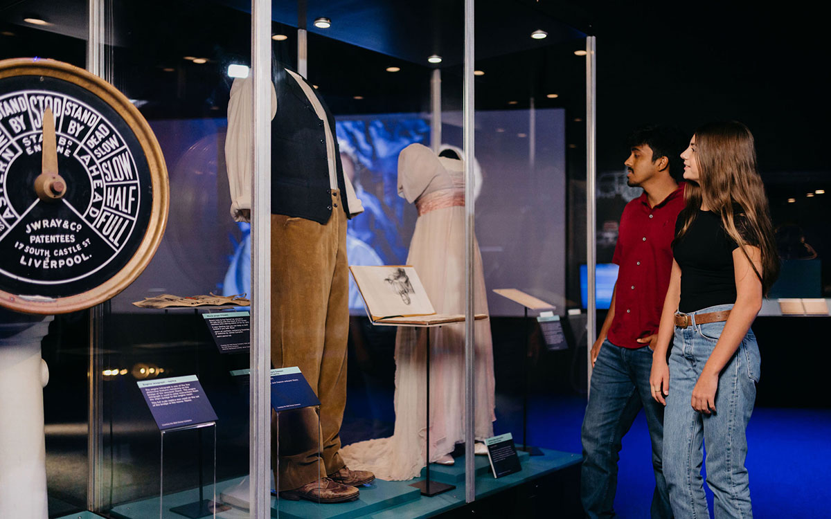 Two people looking at the Titanic exhibition
