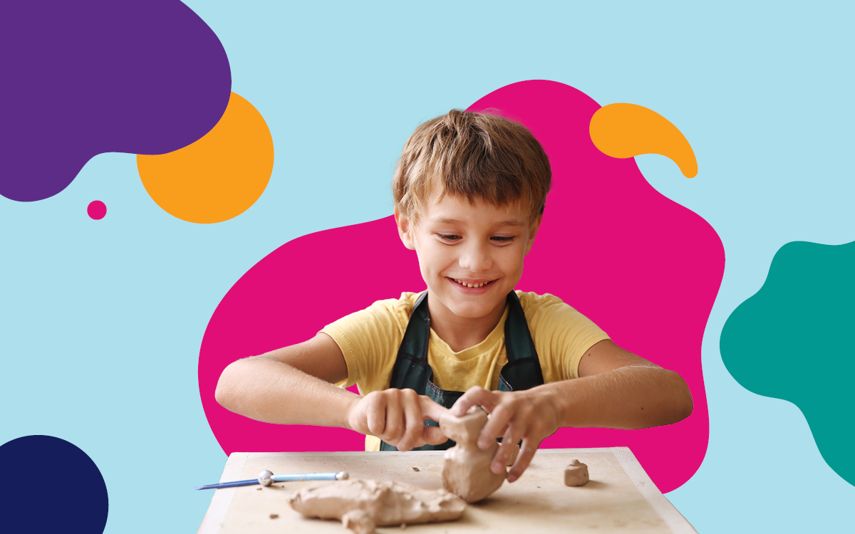 A child smiling while making models