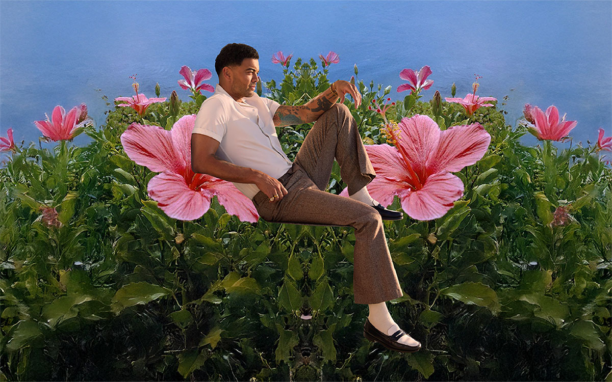 Guy Sebastian sitting in a flower garden