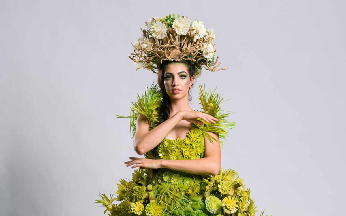 Woman wearing green headpiece and dress