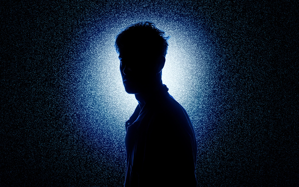 A silhouette against a static noise of light
