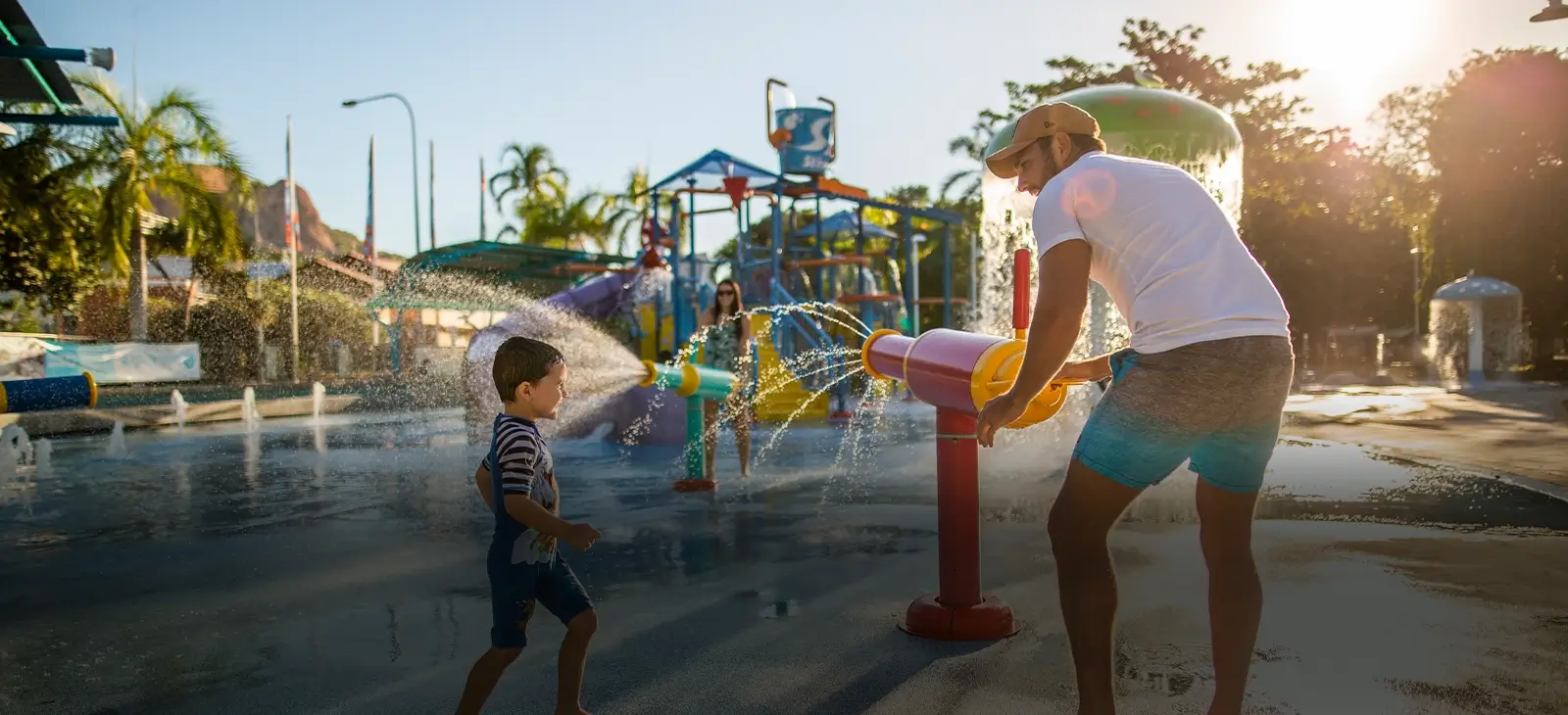 A family playing in the waterpark on a sunny day