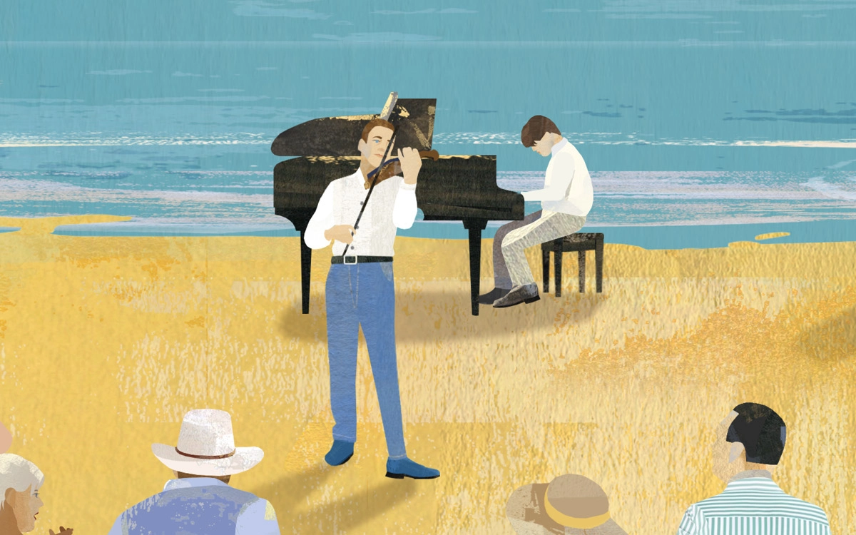 People playing a piano and a violin on the beach