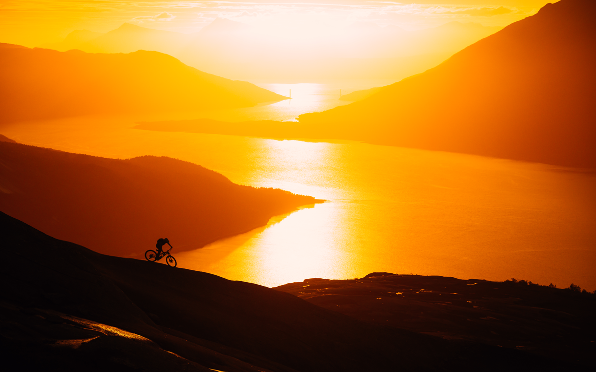 Riding bike on road under sunset