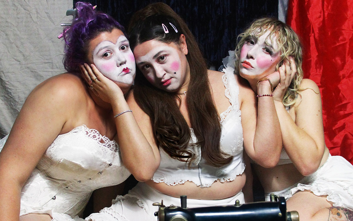 Three female performers on stage