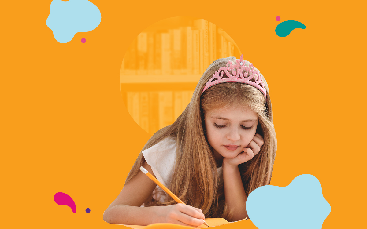 Young girl with a crown writing in a book