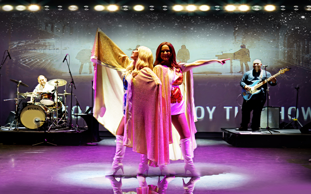 Narelle Ryan and Michelle Birmingham on stage with guitarist and drummer