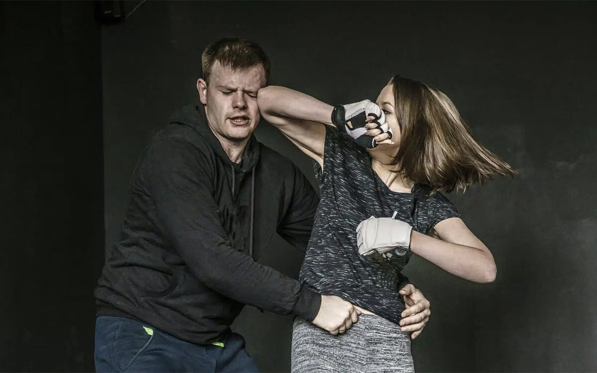 Woman elbowing man in the face