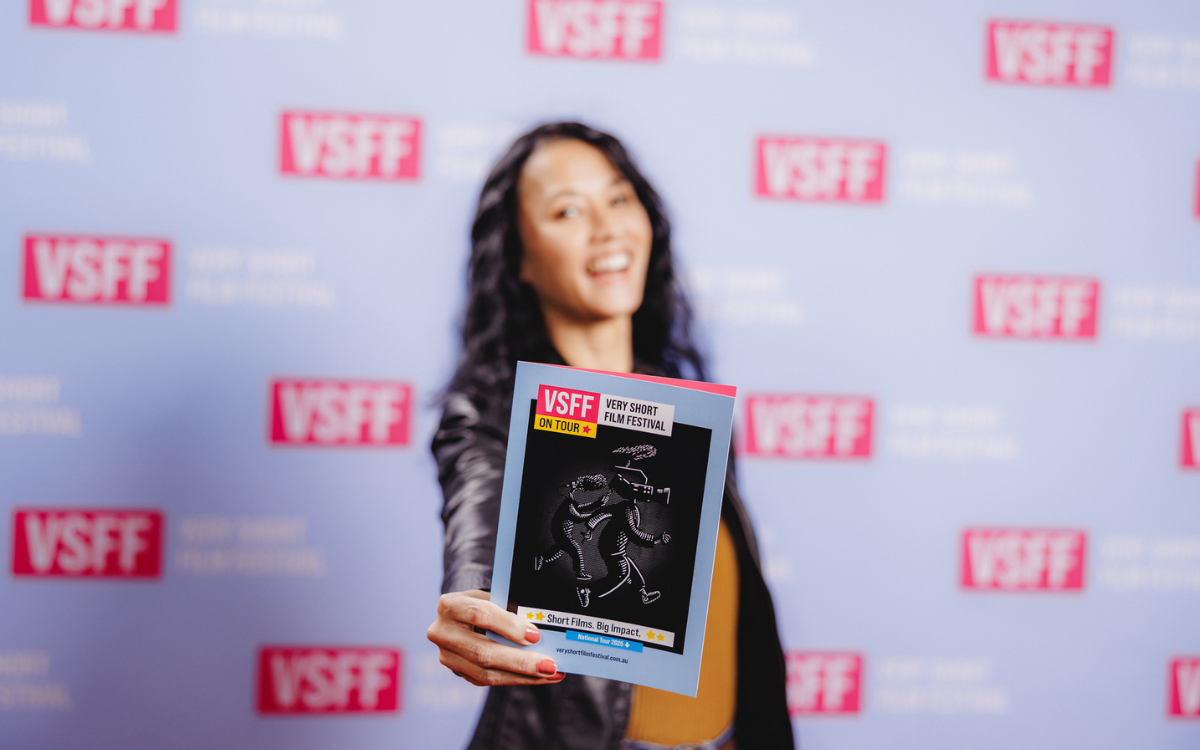 Woman holding film festival program