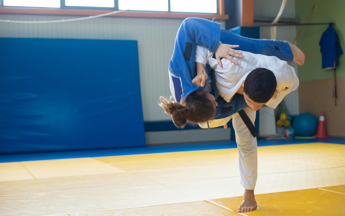 Person throwing another person in Judo class