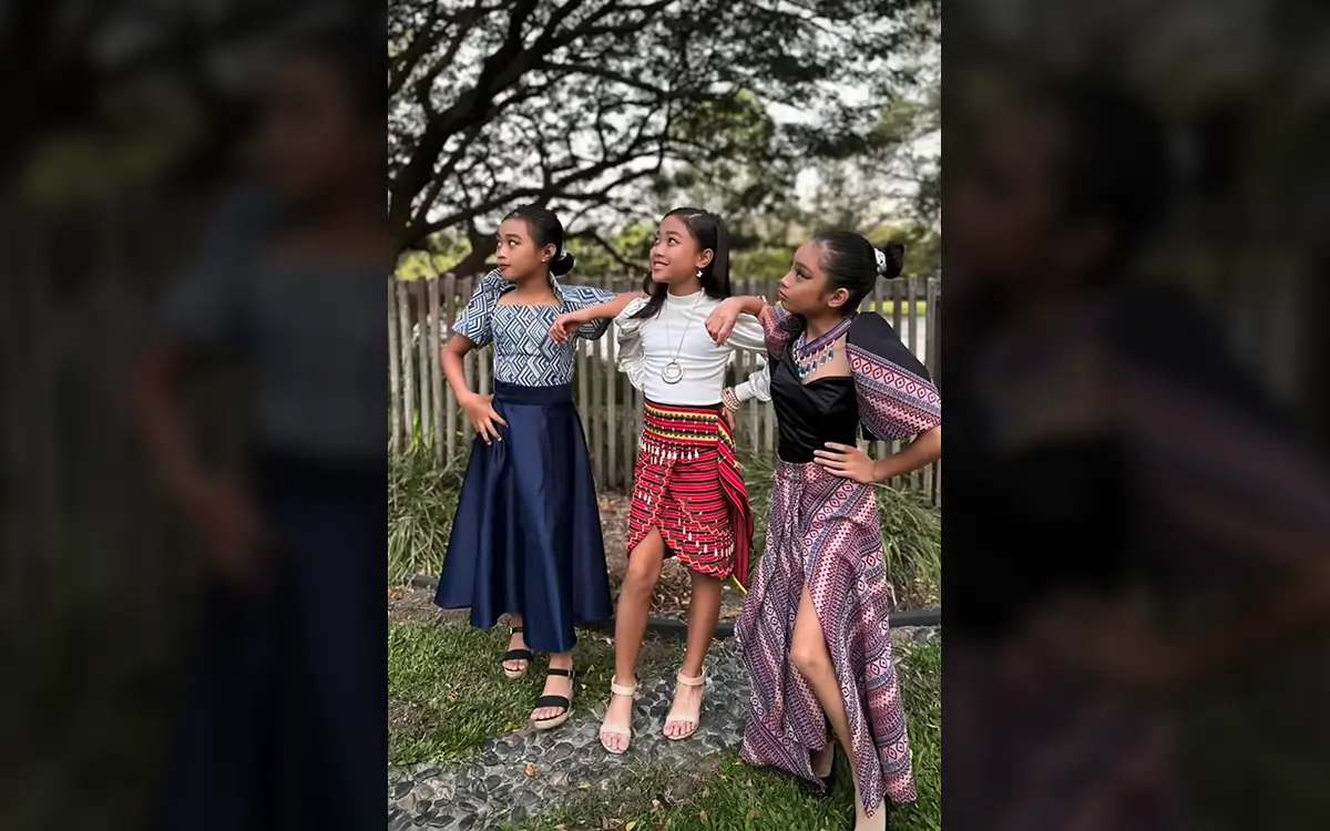 Three girls dressed in traditional Filipino clothing