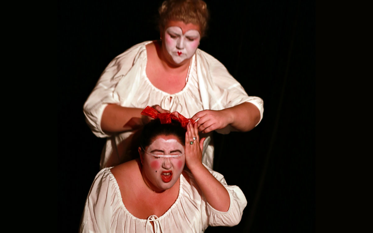 Woman measuring another womans head
