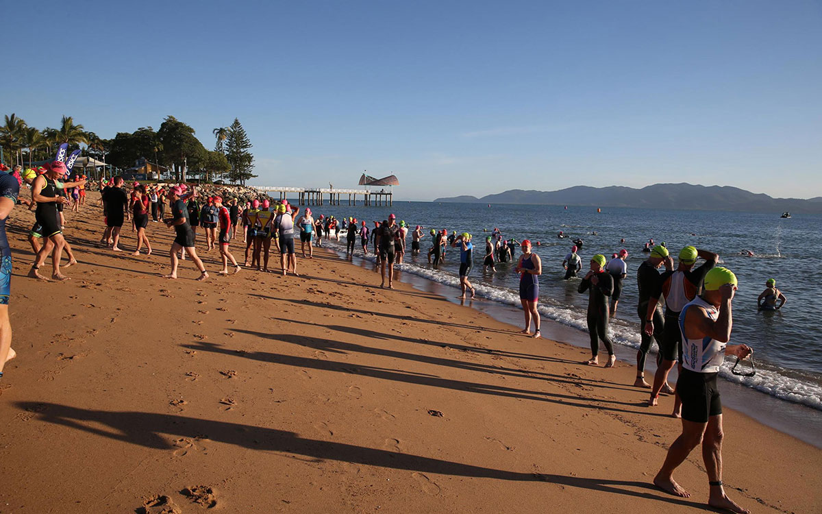 Swimmers waiting on the beach to participate