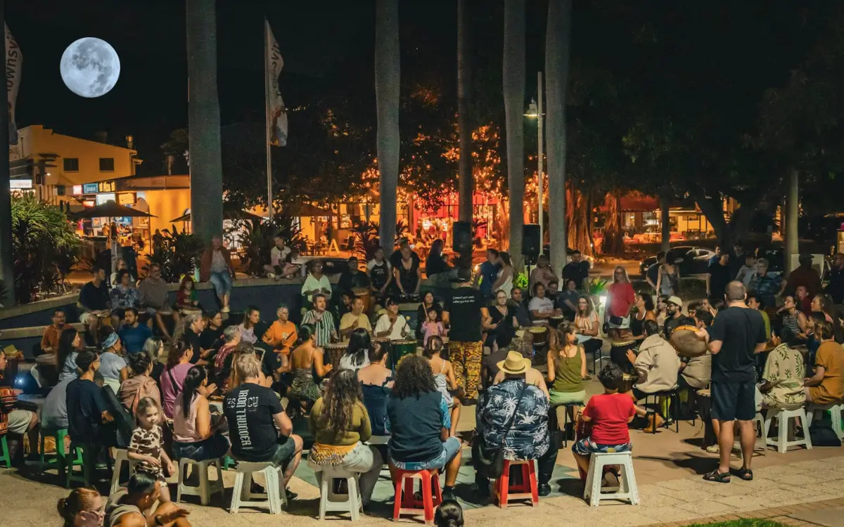 People gathered in a drumming circle during a full moon