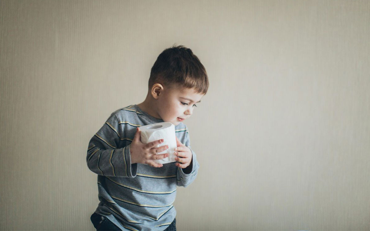 Child holding toilet paper