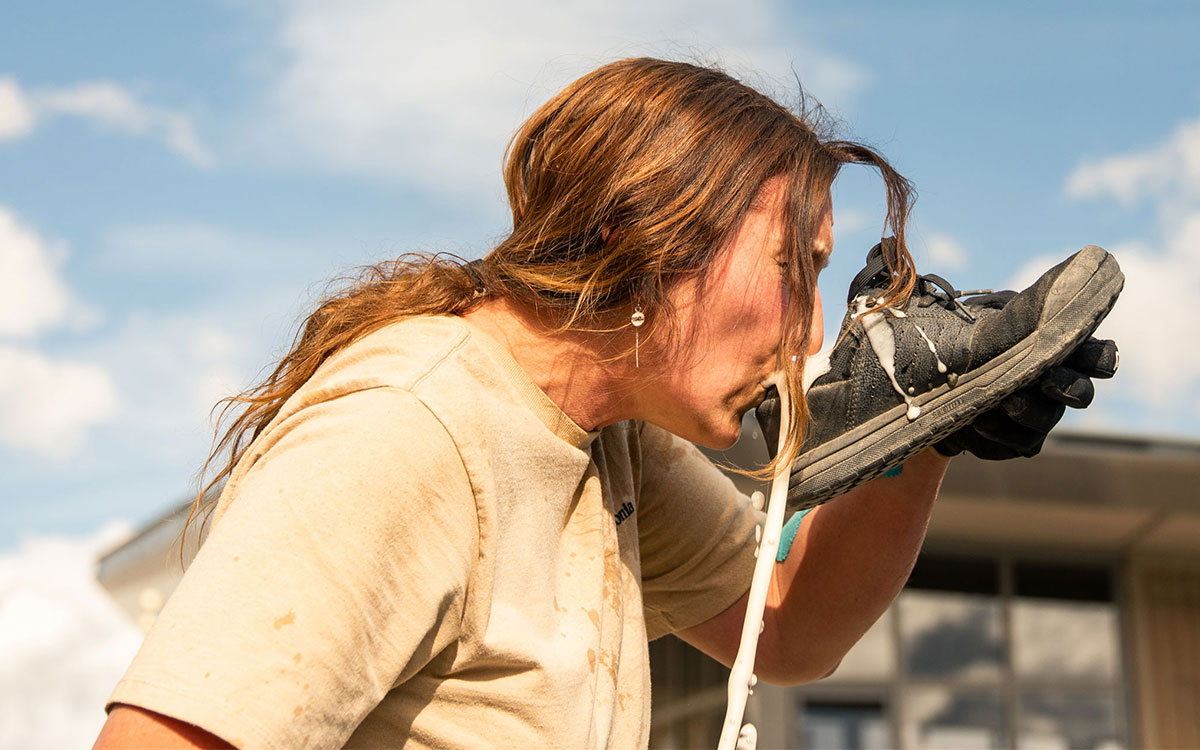 Woman drinking out of a shoe