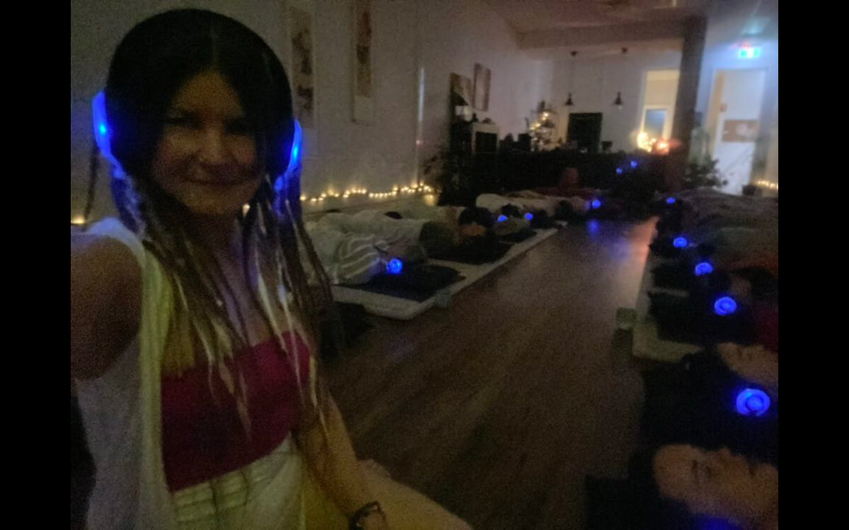 Alli with group of people laying down wearing headphones