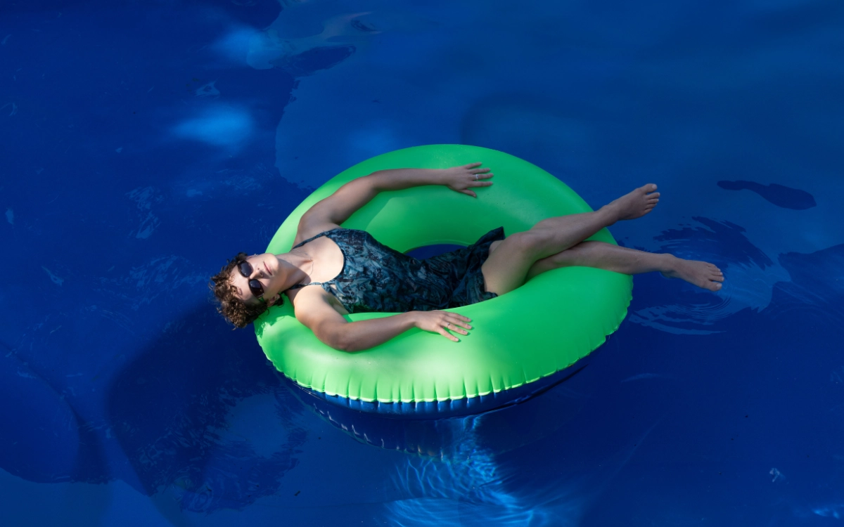 Someone floating on the water in a blow up donut