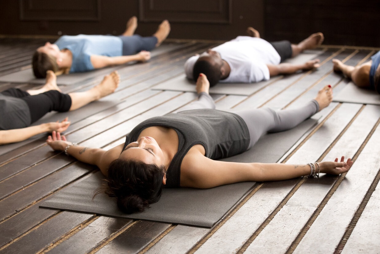 Men and women laying on the floor doing Holotropic Breathwork
